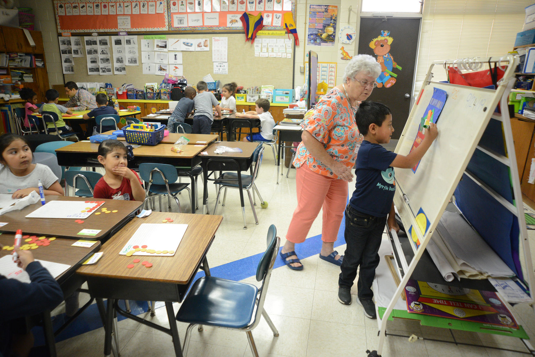 Substitute teacher Vera Warren works with first graders at Robbins Elementary School.